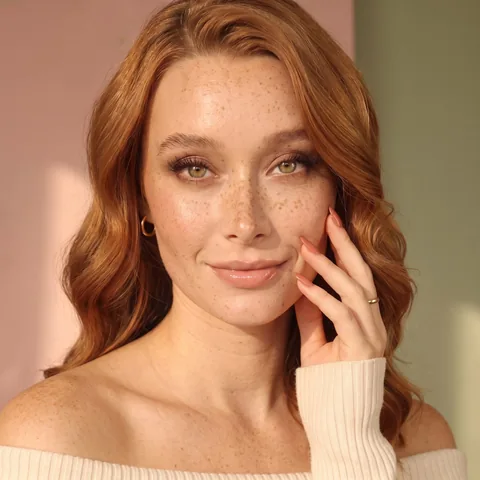 Noor, SOUL's beauty host, with auburn hair and blush almond nails